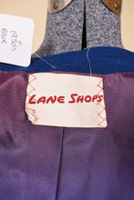 Load image into Gallery viewer, Vintage 1950s blue wool skirt set is shown in close up. This Lane Shops skirt suit has a purple lining. 
