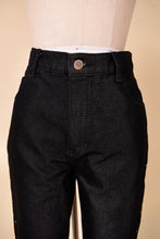 Load image into Gallery viewer, Vintage black denim dark wash high rise flare jeans by Jordache are shown from the front. These jeans have a big silver button. 
