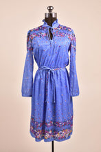 Load image into Gallery viewer, Vintage 1970&#39;s blue floral boho dress is shown from the front. This floral print dress has a keyhole neckline. 
