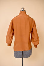 Load image into Gallery viewer, Vintage eighties mutton sleeve brown silk blouse is shown from the back. This silk top has a slight sheen.

