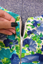 Load image into Gallery viewer, Vintage sixties green and blue floral day dress by Jay Herbert is shown in close up. This dress has a metal zipper up the back. 
