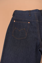 Load image into Gallery viewer, The left back pocket is visible in detail. The pocket has M stitching.
