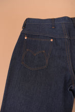 Load image into Gallery viewer, The left back pocket is visible in detail. The pocket has M stitching.