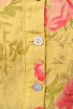 Load image into Gallery viewer, Vintage green and pink floral print linen dress is shown in close up. This dress has shell buttons. 
