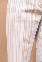 Load image into Gallery viewer, Vintage Y2K designer low rise stripe trousers by Theory are shown in close up. These pants have a vertical stripe pattern with cream, blue, grey, and tan stripes. 
