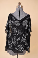 Load image into Gallery viewer, Vintage black sheer flowy top is shown from the front. This top has white floral beaded rose designs. 
