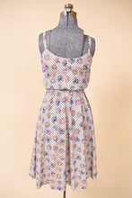 Load image into Gallery viewer, Vintage handmade novelty print midi length dress is shown from the back. This dress has a striped pattern with colorful cartoon bows, hearts. and spades.
