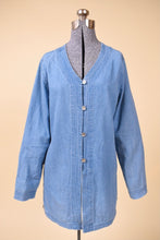 Load image into Gallery viewer, Vintage light wash blue denim button down top by Newport News is shown from the front. This blue top has a v neckline. 
