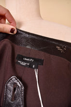 Load image into Gallery viewer, Vintage Y2K dark brown leather pants are shown in close up. These pants are Made in Canada by the brand Identify.
