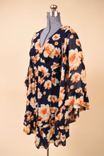 Load image into Gallery viewer, Vintage early 2000's navy blue ruffle mini dress by Betsey Johnson is shown from the side. This dress has a v neckline.