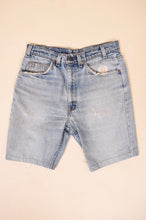 Load image into Gallery viewer, Vintage 1970&#39;s blue denim distressed orange tab shorts by Levi&#39;s are shown from the front. 
