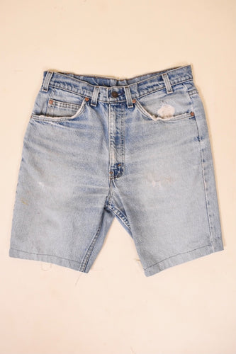 Vintage 1970's blue denim distressed orange tab shorts by Levi's are shown from the front. 