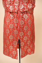 Load image into Gallery viewer, Vintage red and metallic lace sixties mini dress is shown in close up. This dress has a slit at the back of the skirt.