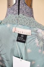 Load image into Gallery viewer, Vintage Y2K sky blue mini slip is shown in close up. This slip is by the brand Harknam and tagged a size M.
