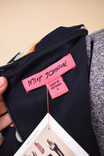 Load image into Gallery viewer, Y2K sheer navy blue flower print dress is shown in close up. This ruffled mini dress has a tag that reads Betsey Johnson.