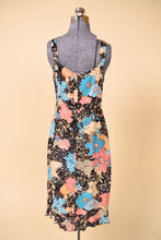 Load image into Gallery viewer, Vintage nineties multicolor floral print dress by Loco Lindo is shown from the back. This floral print ruffled midi dress has black flowers.