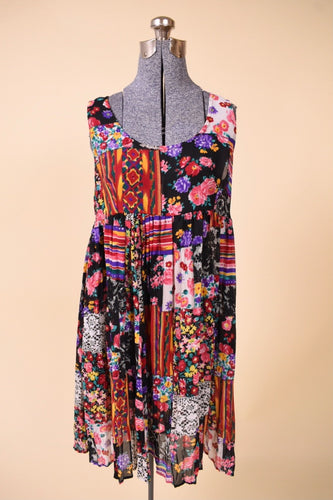 Vintage multicolor patchwork print rayon mini dress by Ultimate is shown from the front. This dress has a bright floral patchwork pattern. 