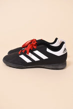 Load image into Gallery viewer, Vintage black, white, and red soccer cleats by Adidas are shown from the side.
