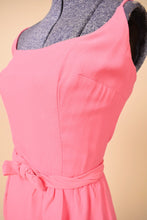 Load image into Gallery viewer, Vintage pink mini dress is shown in close up. This dress has a bow belt at the waist.