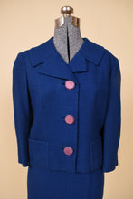 Load image into Gallery viewer, Vintage 1950s two piece cobalt blue wool blazer is shown in close up. This blazer have chunky contrast purple buttons down the front. 
