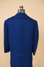 Load image into Gallery viewer, Vintage fifties wool blue blazer is shown from the back. This cropped blazer has 3/4 sleeves. 
