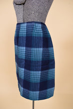 Load image into Gallery viewer, Vintage 70s blue plaid wool mini skirt is shown from the side. 
