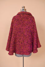 Load image into Gallery viewer, Vintage Irish wool pink and orange woven boucle cape is shown from the back. This cape has a turtleneck.