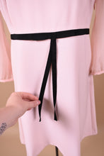 Load image into Gallery viewer, Vintage Ted Baker London pale pink babydoll dress is shown in close up. This dress has a black ribbon at the waist.
