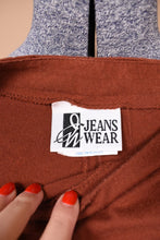 Load image into Gallery viewer, Vintage western rust colored cotton shirt is shown in close up. This shirt has a tag that reads Jeans Wear.

