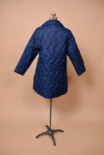 Load image into Gallery viewer, Vintage long puffy quilted navy blue coat is shown from the back. 
