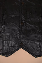 Load image into Gallery viewer, Vintage 90's black leather patchwork vest is shown in close up.