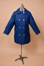 Load image into Gallery viewer, Vintage navy blue quilted puffy jacket is shown from the front. This jacket has shiny silver double breasted buttons down the front.
