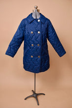 Load image into Gallery viewer, Vintage navy blue quilted puffy jacket is shown from the front. This jacket has shiny silver double breasted buttons down the front.