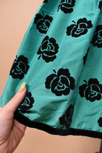 Load image into Gallery viewer, Green and black 80&#39;s Escada rose print party dress is shown in close up. This dress has a floral rose print.
