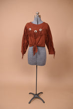 Load image into Gallery viewer, Vintage rust colored long sleeve western top with fringe is shown from the front.
