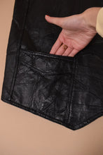 Load image into Gallery viewer, Vintage 90's black American Flag leather patchwork vest is shown in close up. This vest has two small front pockets.