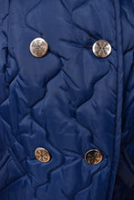 Load image into Gallery viewer, Vintage navy blue quilted jacket is shown in close up. This jacket has silver buttons with snowflake designs.
