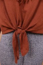 Load image into Gallery viewer, Vintage rust colored long sleeve cropped top is shown in close up. This top has a tie waist accent.
