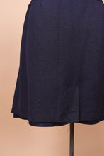 Load image into Gallery viewer, The bottom of the skirt is seen up close. The skirt appears to have a lining.
