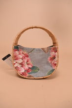 Load image into Gallery viewer, Vintage woven circle bag is shown from the front. This bag has a rhododendron print fabric.
