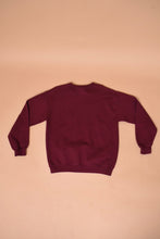 Load image into Gallery viewer, The sweatshirt lies flat on the ground. The back of the sweatshirt is visible.