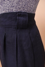 Load image into Gallery viewer, One of the skirt belt loops is seen up close. The skirt has slight pleating.
