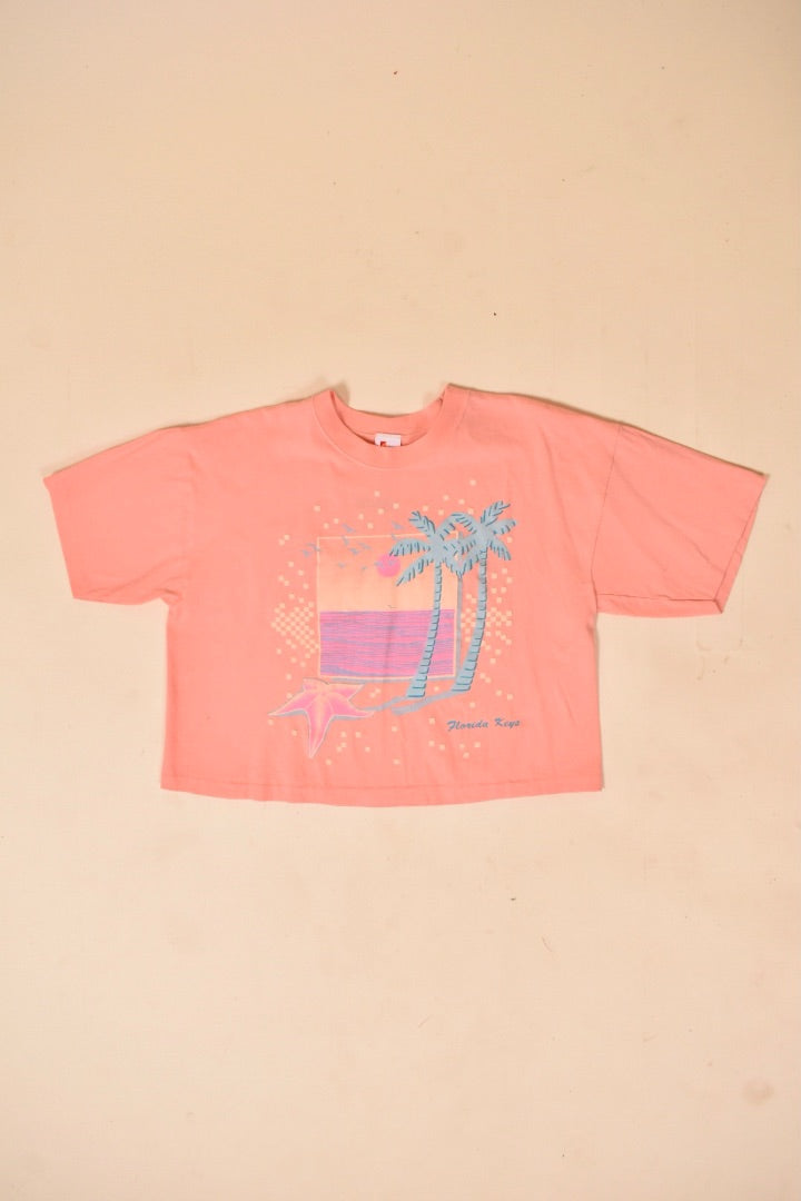 80s Florida Keys tee is shown from the front. The tee is peach.