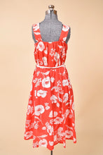 Load image into Gallery viewer, 70&#39;s red and white floral dress is shown from the back. This dress has an elastic waist.
