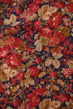 Load image into Gallery viewer, Fabric of Laura Ashley pants is shown up close. The pants are red, navy, and brown floral.
