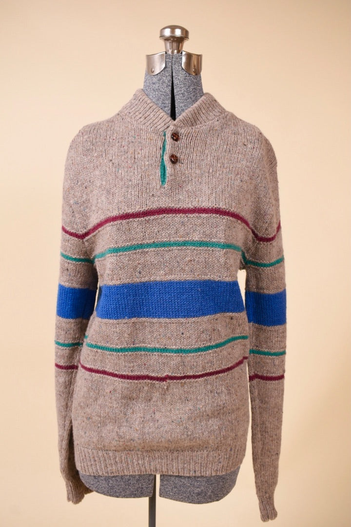 Sweater is shown from the front. The sweater has colorful stripes.