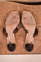Load image into Gallery viewer, Desinger heels are shown from the bottom. The shoes have a square toe.
