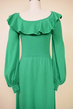 Load image into Gallery viewer, Vintage midi length skirt is shown from the side. The skirt has a zipper.
