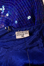 Load image into Gallery viewer, 80s blue sequin dress shown close up with fabric content label reading 100% pure silk with rayon lining
