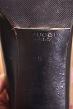 Load image into Gallery viewer, Tall black heels are shown close up. Gucci shoes were made in Italy.
